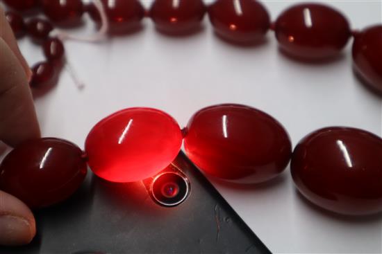 A single strand graduated simulated cherry amber necklace, gross weight 95 grams,
